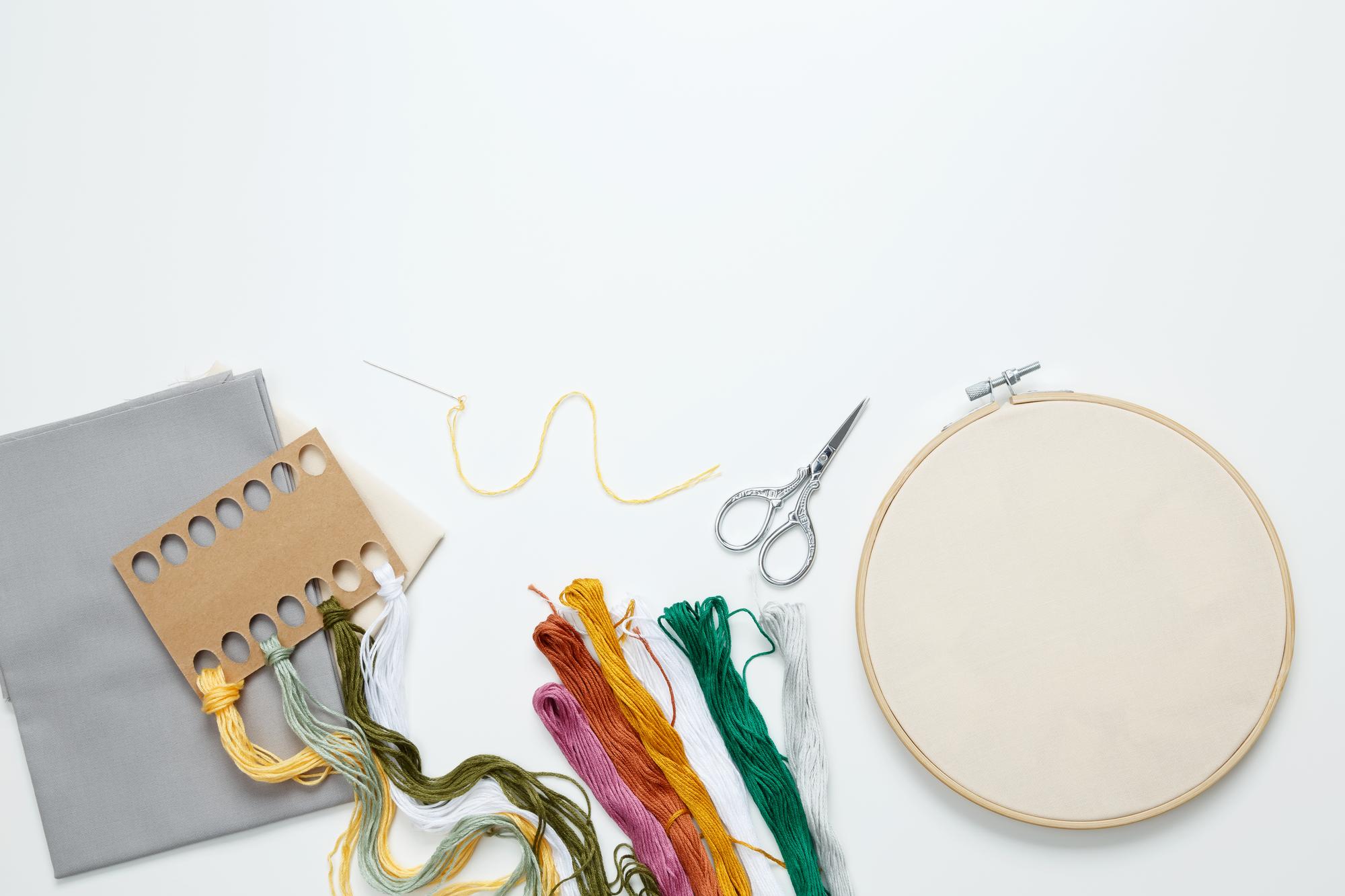 Three embroidered samples on a table